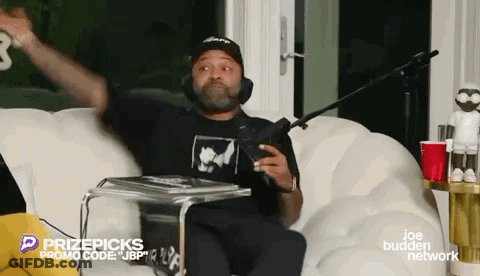 Man Sitting On Couch With Microphone GIF