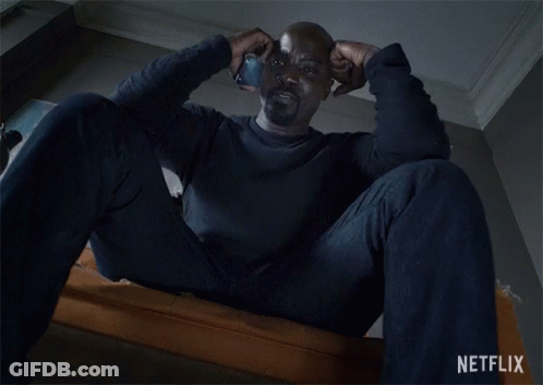 Man Sitting On Couch With Netflix Logo GIF