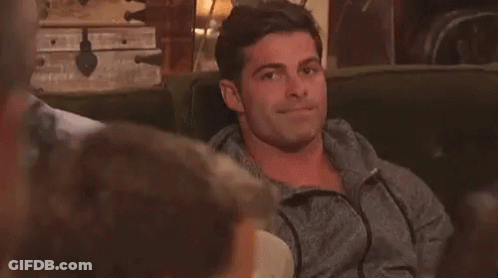 Man Sitting On Couch With Others Looking At Camera GIF
