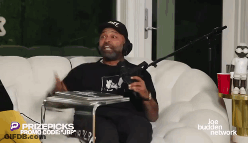 Man Sitting On Couch With PrizePicks Promo Code GIF