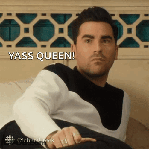 Man Sitting On Couch With Yass Queen Behind Him GIF