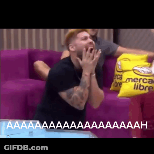 Man Sitting On Couch With Yellow Pillow Saying Mercado Libre GIF