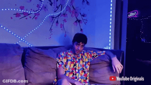 Man Sitting On Couch With YouTube Originals Logo GIF