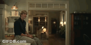 Man Sitting On Counter Looking Out Window GIF