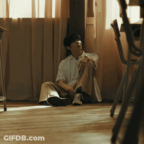 Man Sitting On Floor By Window GIF