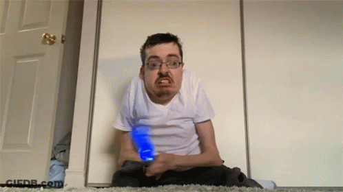 Man Sitting On Floor Holding Blue Light GIF
