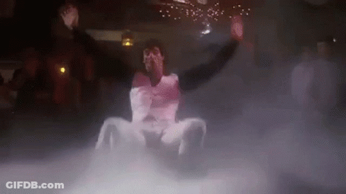 Man Sitting On Floor In Dark Room Surrounded By Smoke GIF