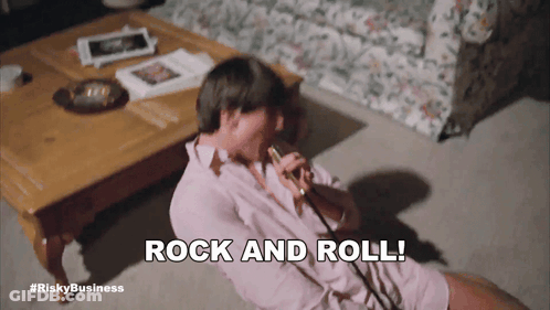 Man Sitting On Floor Saying Rock And Roll GIF