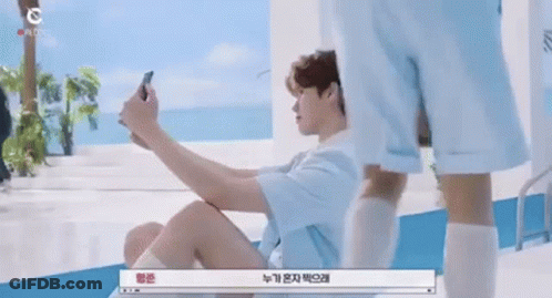 Man Sitting On Floor Taking Selfie GIF