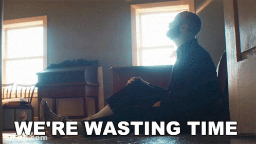Man Sitting On Floor We're Wasting Time GIF