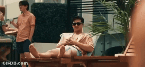 Man Sitting On Lawn Chair Looking At Phone GIF