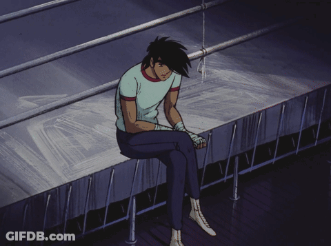 Man Sitting On Ledge With Head Down GIF