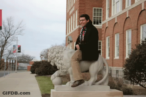 Man Sitting On Lion Statue GIF