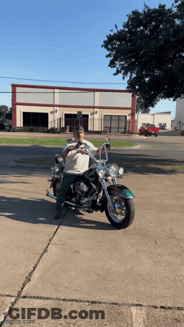 Man Sitting On Motorcycle In Desert With Woman Behind GIF