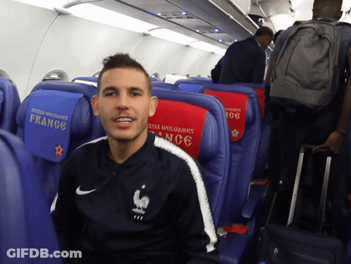 Man Sitting On Plane In Nike Jacket Saying France GIF