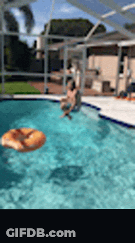 Man Sitting On Pool Edge With Donut Float GIF