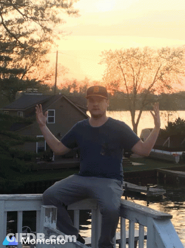 Man Sitting On Railing Saying Momento GIF