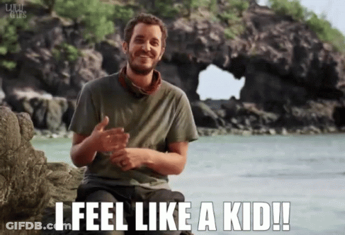 Man Sitting On Rock Saying I Feel Like A Kid GIF