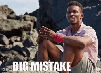 Man Sitting On Rocky Beach Saying Big Mistake GIF