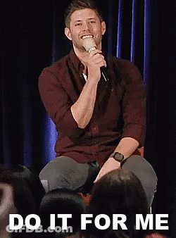 Man Sitting On Stage Holding Microphone GIF