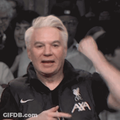 Man Sitting On Stool Holding Microphone GIF