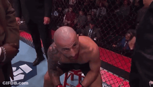 Man Sitting On Stool In Boxing Ring With Crowd GIF
