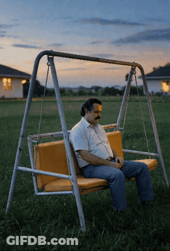 Man Sitting On Swing At Sunset GIF