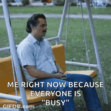 Man Sitting On Swing In Park GIF