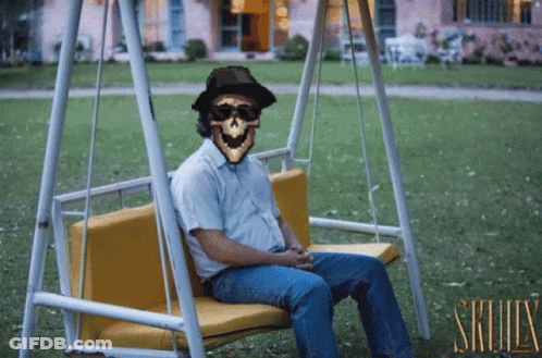Man Sitting On Swing With Skull GIF