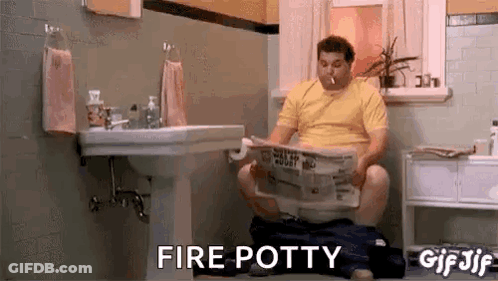 Man Sitting On Toilet Reading Newspaper Smoking Cigarette GIF