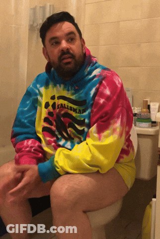 Man Sitting On Toilet Wearing Tie Dye Calimar Shirt GIF