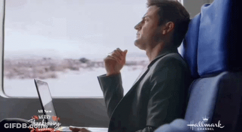 Man Sitting On Train Looking Out Window Hallmark Channel Logo GIF