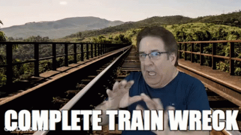 Man Sitting On Train Tracks Saying Complete Train Wreck GIF