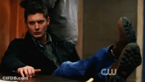 Man Sitting With Feet Up Pointing At Camera GIF