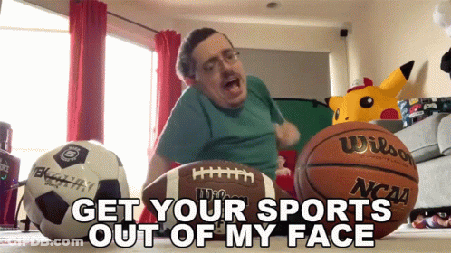 Man Sitting With Football And Basketball Saying Get Your Sports Out Of My Face GIF