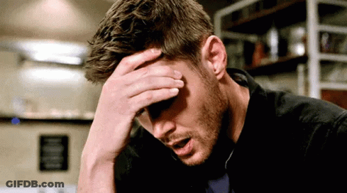 Man Sitting With Hand On Head GIF