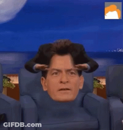 Man Sitting With Head In Turtleneck GIF