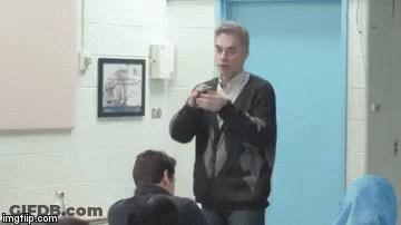 Man Sitting With Serious Expression GIF