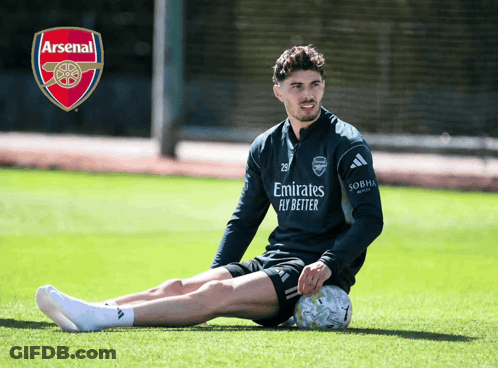 Man Sitting With Soccer Ball And Arsenal Logo GIF