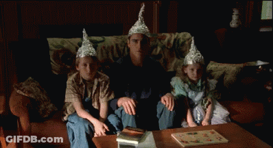Man Sitting With Two Children In Tin Foil Hats GIF