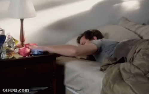 Man Sleeping In Bed Next To Lamp And Nightstand GIF