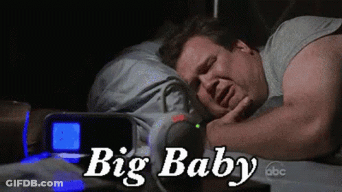 Man Sleeping In Bed With Big Baby Alarm Clock GIF