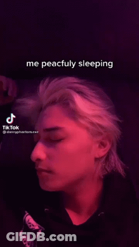 Man Sleeping In Dark Room With TikTok Video GIF