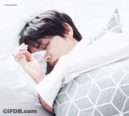 Man Sleeping On Bed With Gray And White Striped Blanket GIF