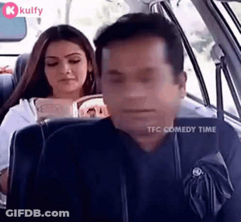 Man Sleeping While Woman Reads In Car GIF