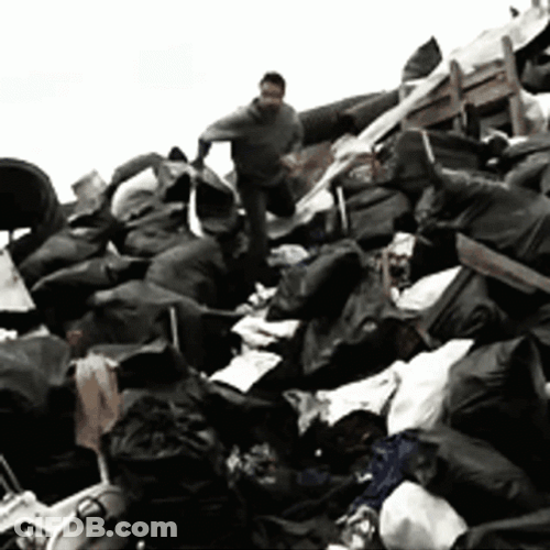 Man Sliding In Garbage Dump GIF