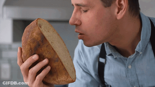 Man Smelling Loaf Of Bread GIF