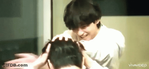Man Smiling And Touching Another's Head GIF