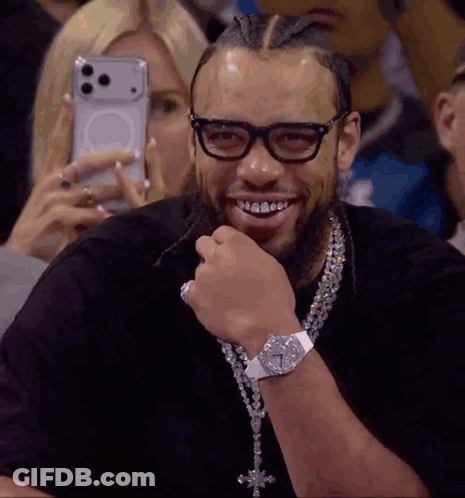 Man Smiling As Woman Photographs Him GIF