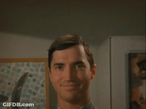 Man Smiling At Camera In Front Of Painting GIF